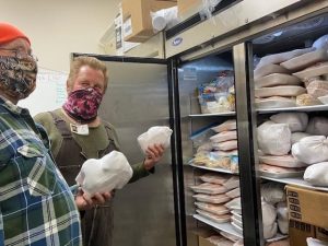 volunteers stock meat freezer