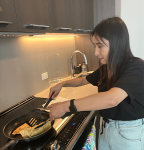 Recently sponsored, an Afghan woman cooks in her new Canadian home.